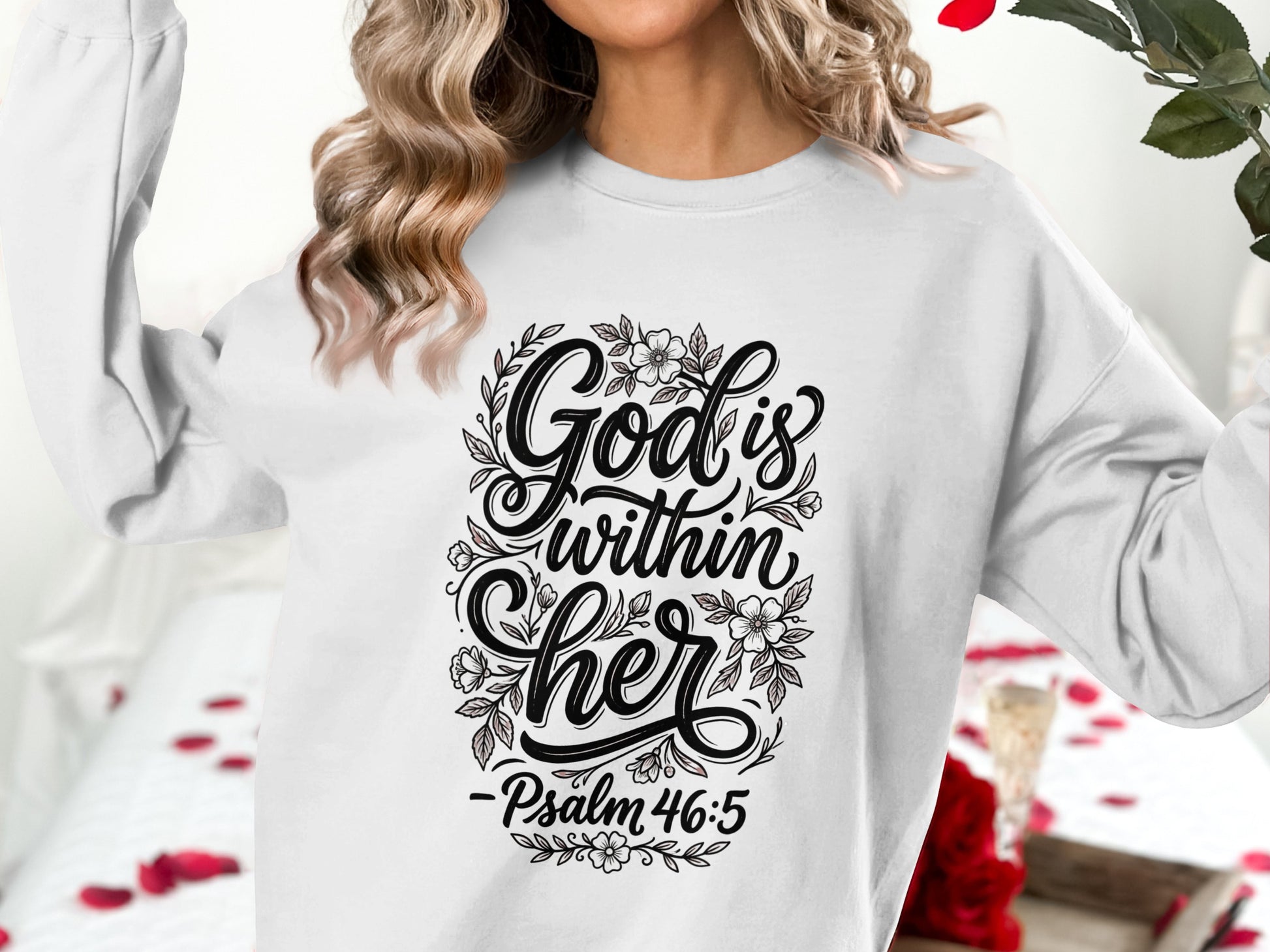 White sweatshirt with "God is within her" text and floral design.