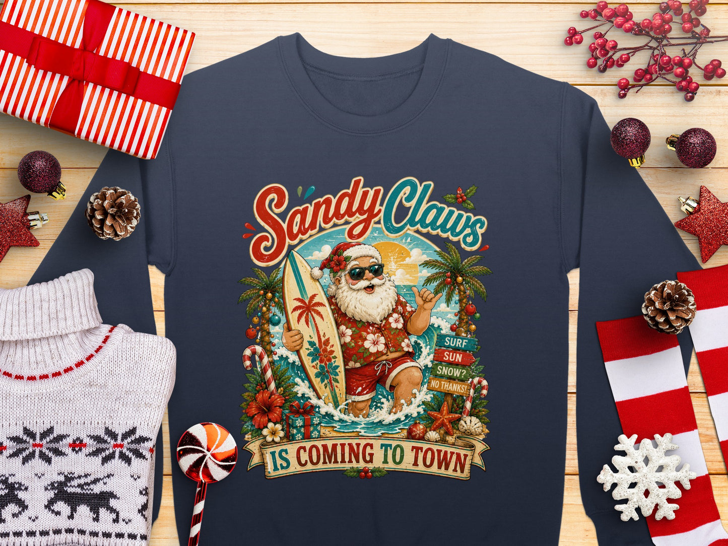 Santa Claus on a surfboard with "Sandy Claws Is Coming To Town" text.
