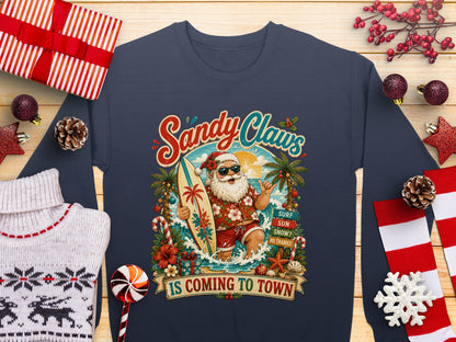 Santa Claus on a surfboard with "Sandy Claws Is Coming To Town" text.