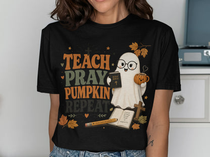 T-shirt graphic with ghost holding Bible and pumpkin mug, "TEACH PRAY PUMPKIN REPEAT" text.