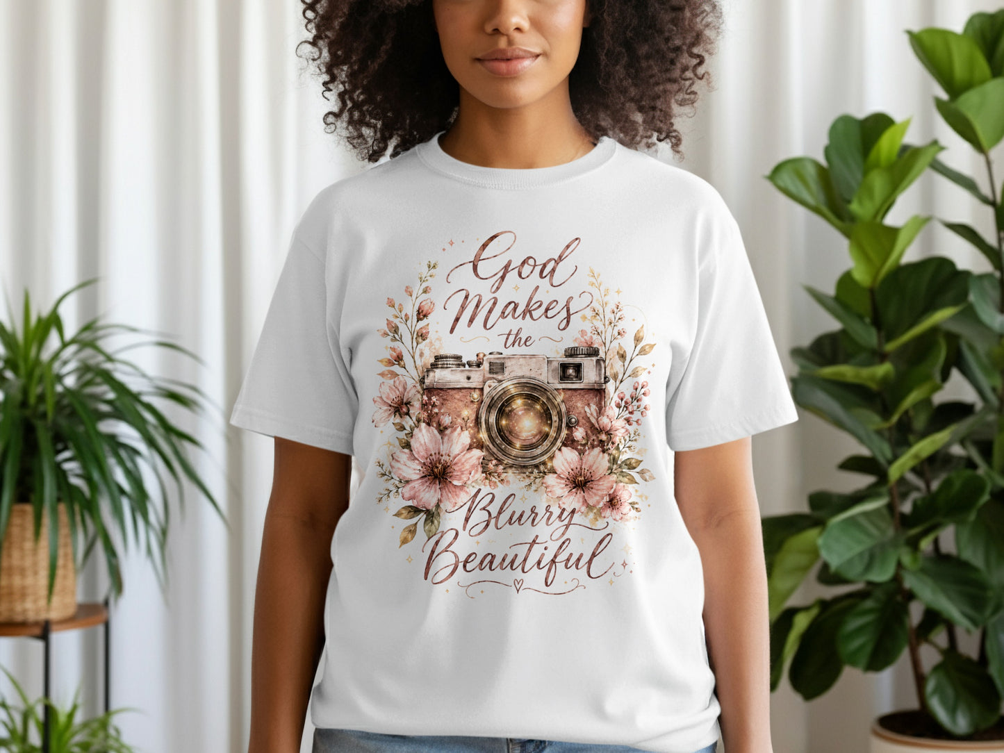 White t-shirt with floral camera graphic and text "God Makes the Blurry Beautiful."