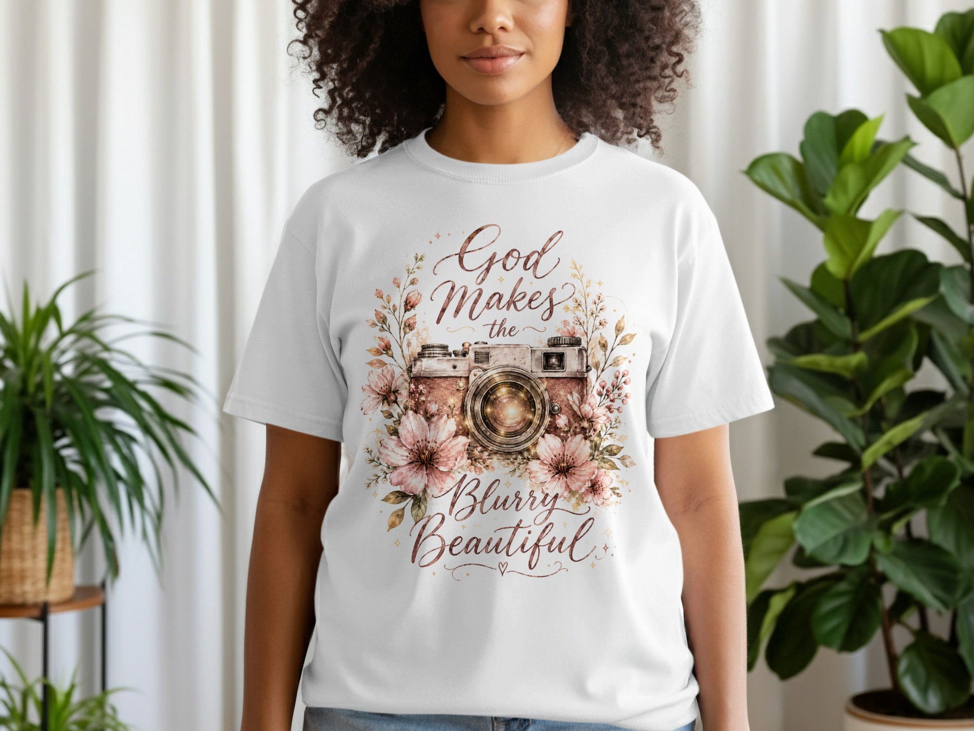 White t-shirt with floral camera graphic and text "God Makes the Blurry Beautiful."