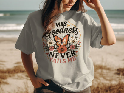 Gray t-shirt with "HIS GOODNESS NEVER FAILS ME" text and floral butterfly design.