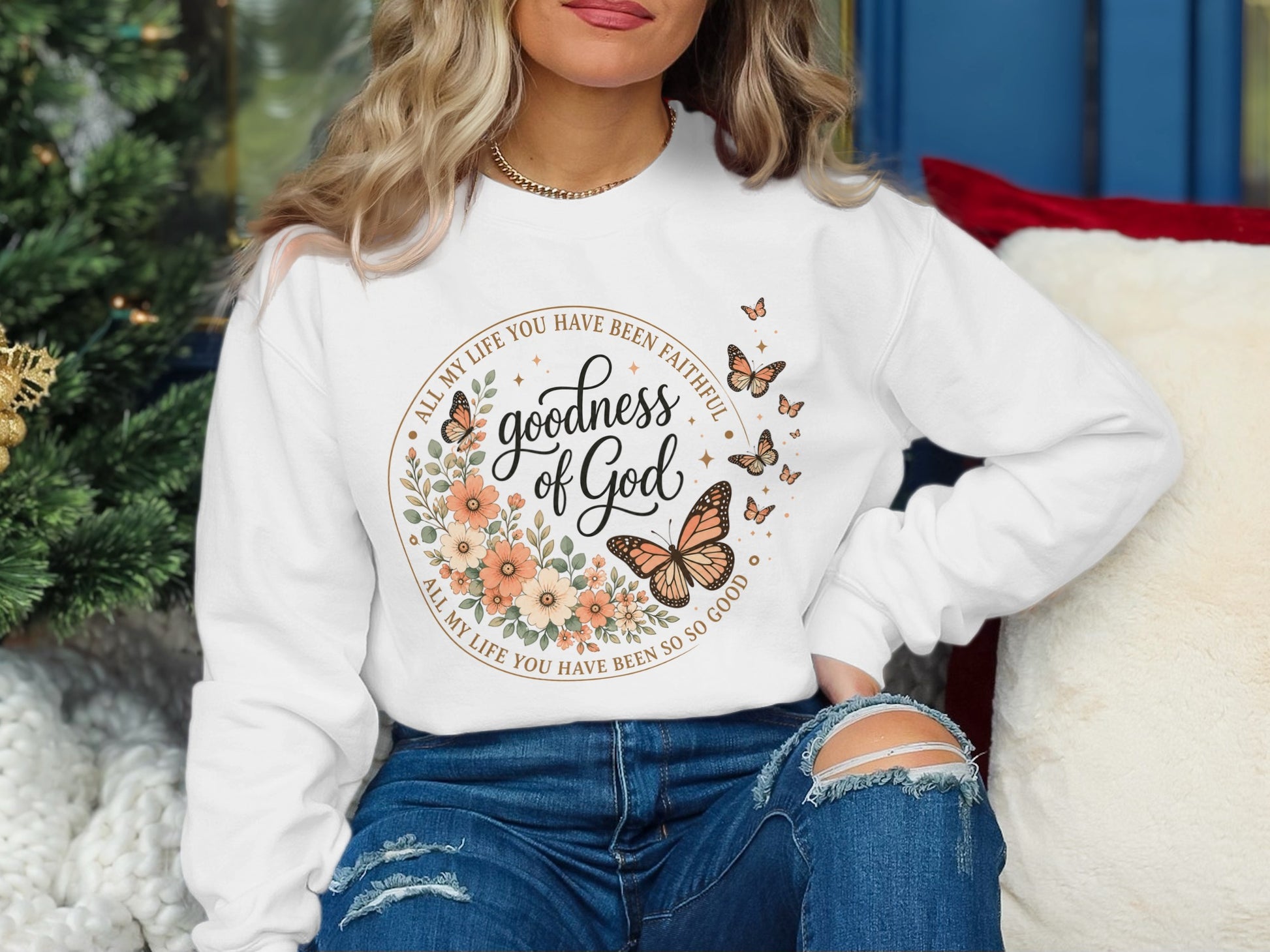 White sweatshirt with "Goodness of God" and butterflies in floral wreath design.