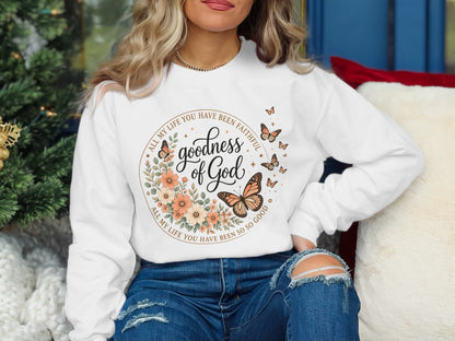 White sweatshirt with "Goodness of God" and butterflies in floral wreath design.