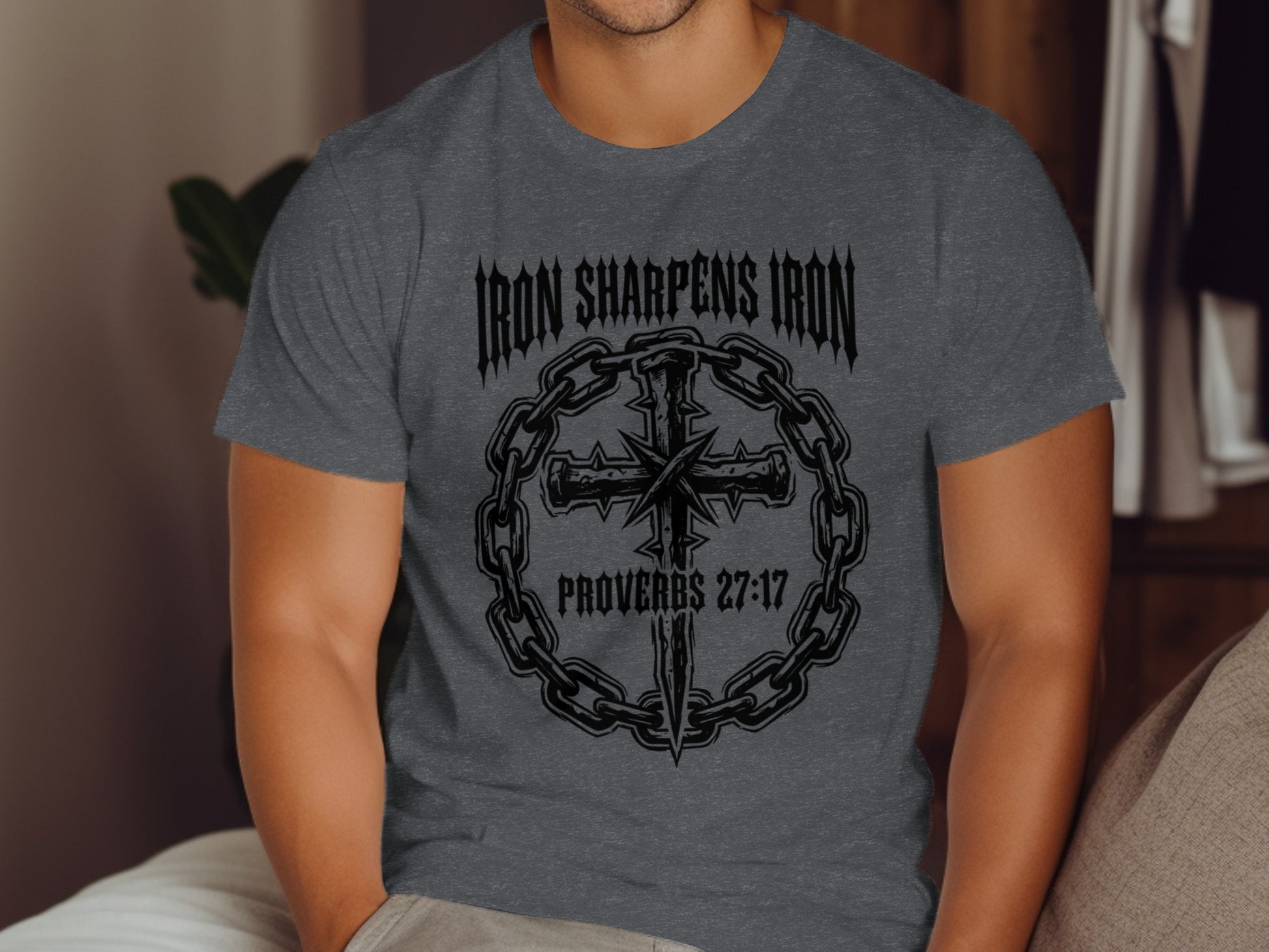 Dark gray t-shirt with "Iron Sharpens Iron Proverbs 27:17" and cross design.