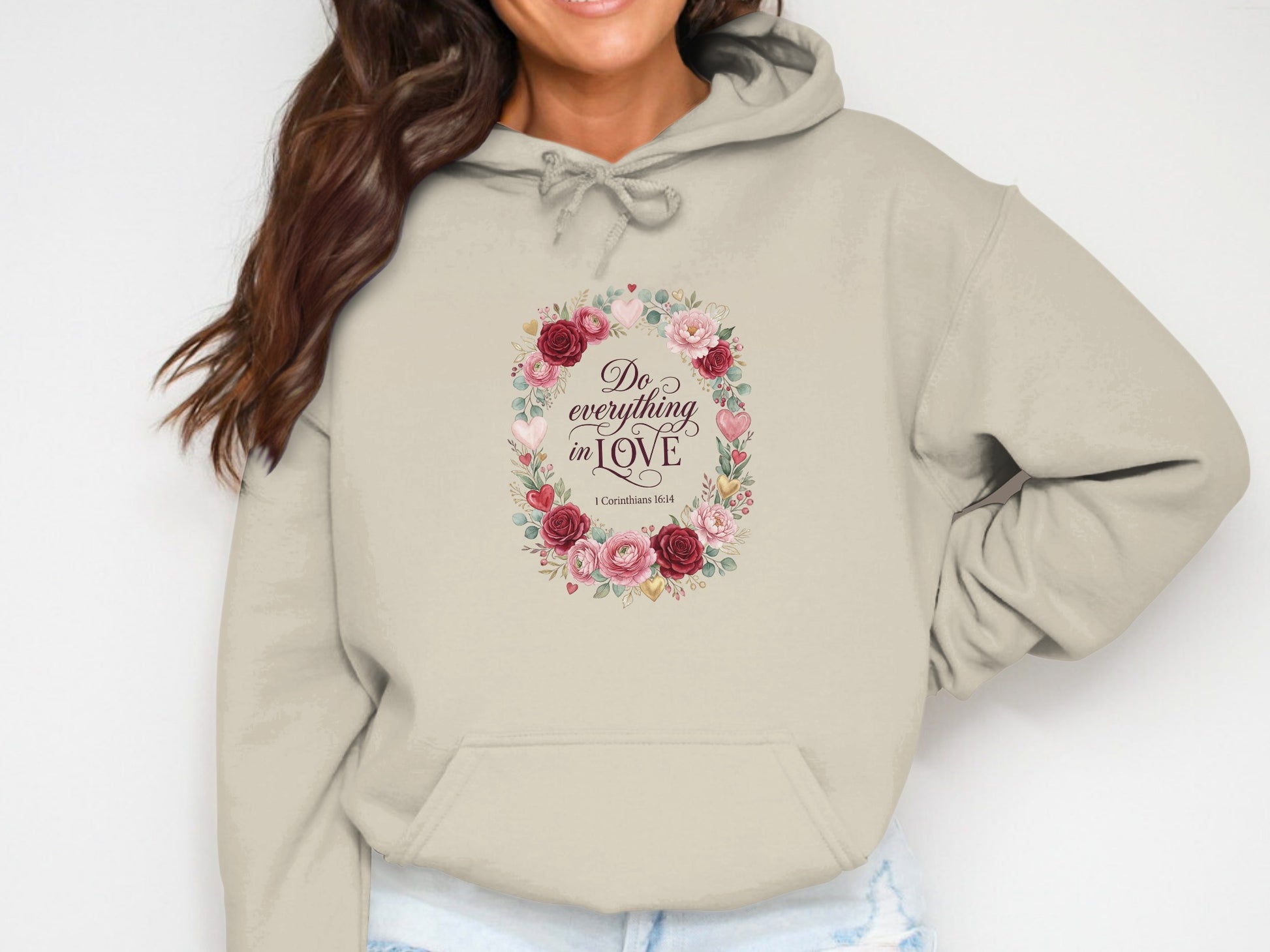Beige hoodie with "Do everything in love" and floral wreath graphic.