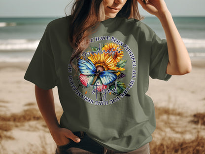 T-shirt with butterfly, sunflower, and "Goodness you have been faithful all my life" text.
