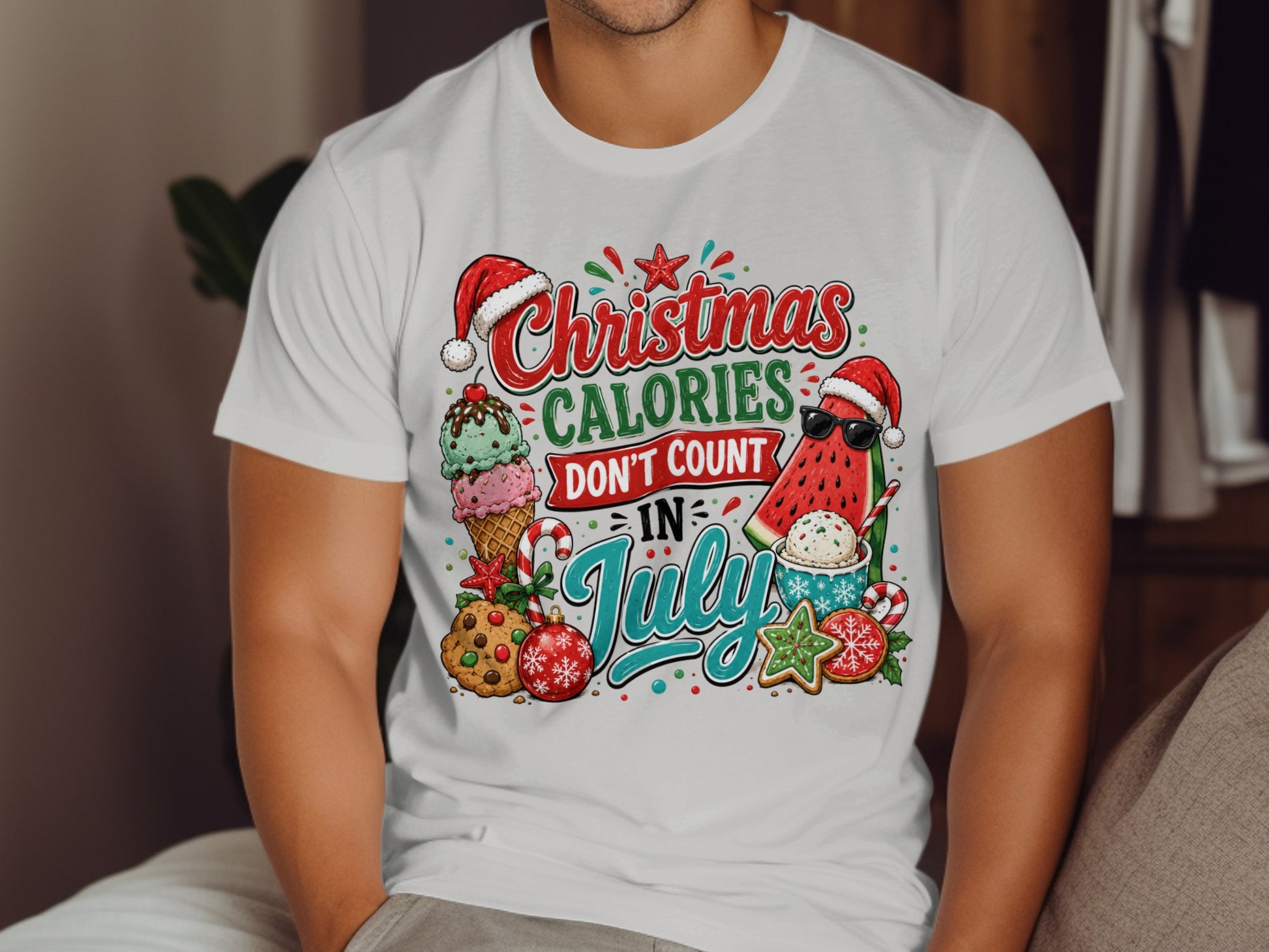 T-shirt with "Christmas Calories Don't Count in July" text and festive summer-themed graphics.