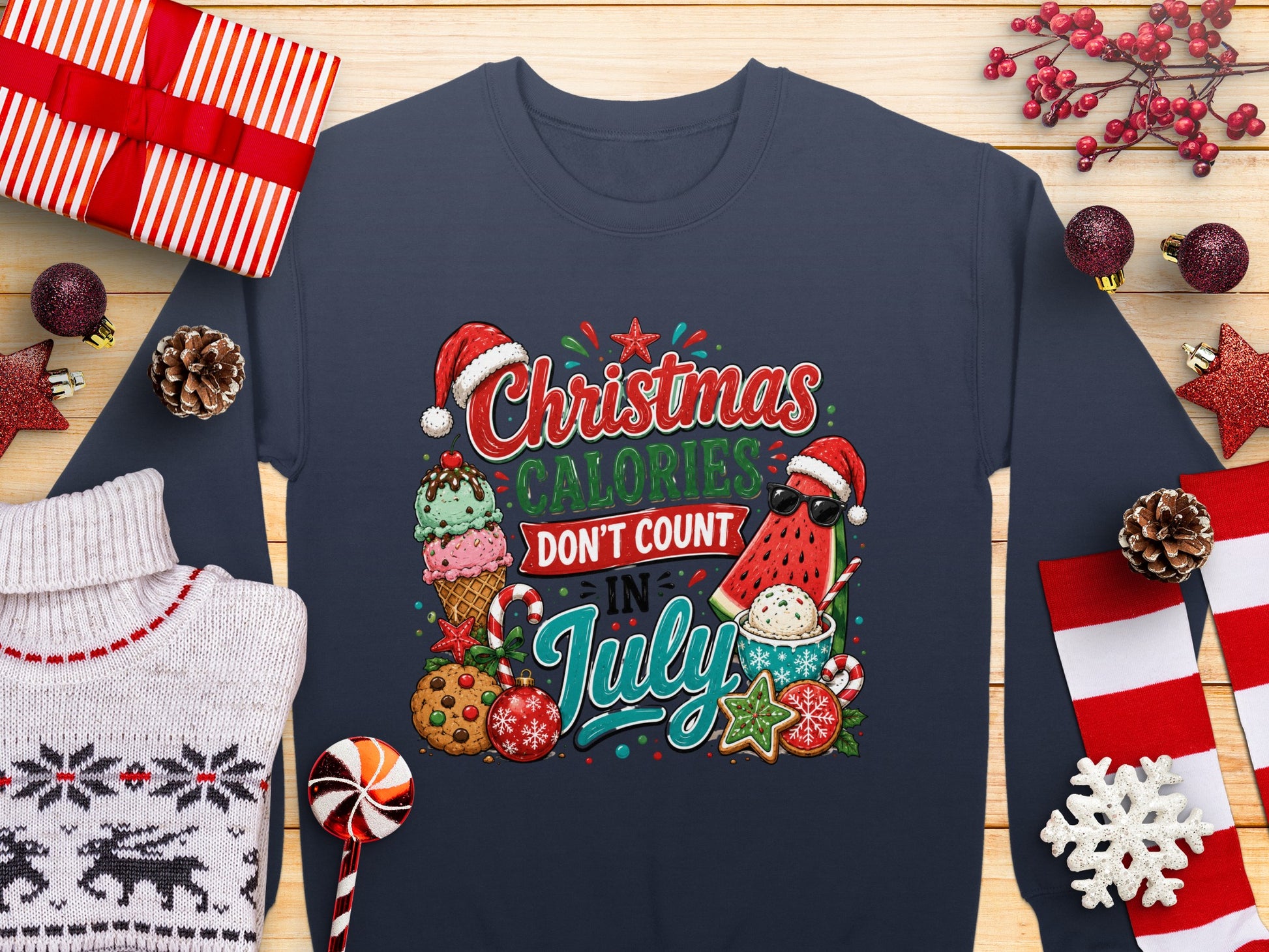 Christmas Calories Don't Count In July graphic on a navy sweatshirt with holiday decorations.