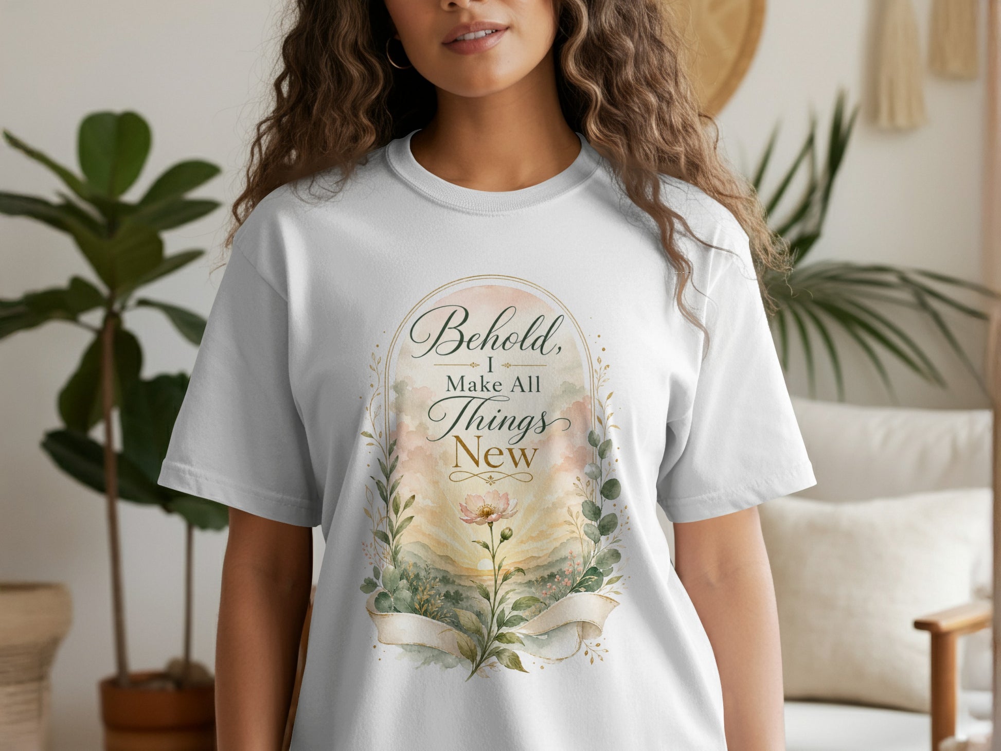White t-shirt with floral illustration and text "Behold, I Make All Things New."