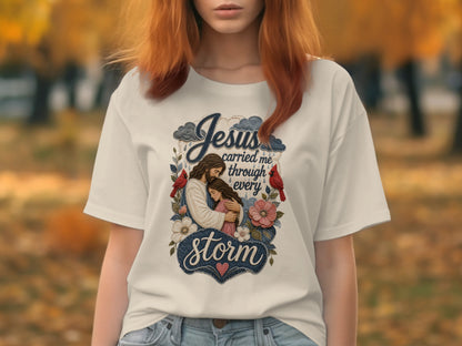 T-shirt with "Jesus carried me through every storm" text and religious illustration.