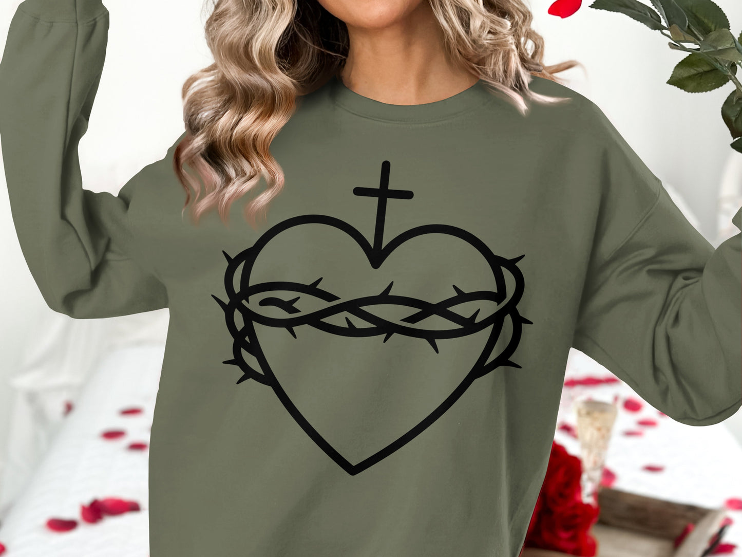 Olive green sweatshirt with a black outline of a heart, cross, and crown of thorns.