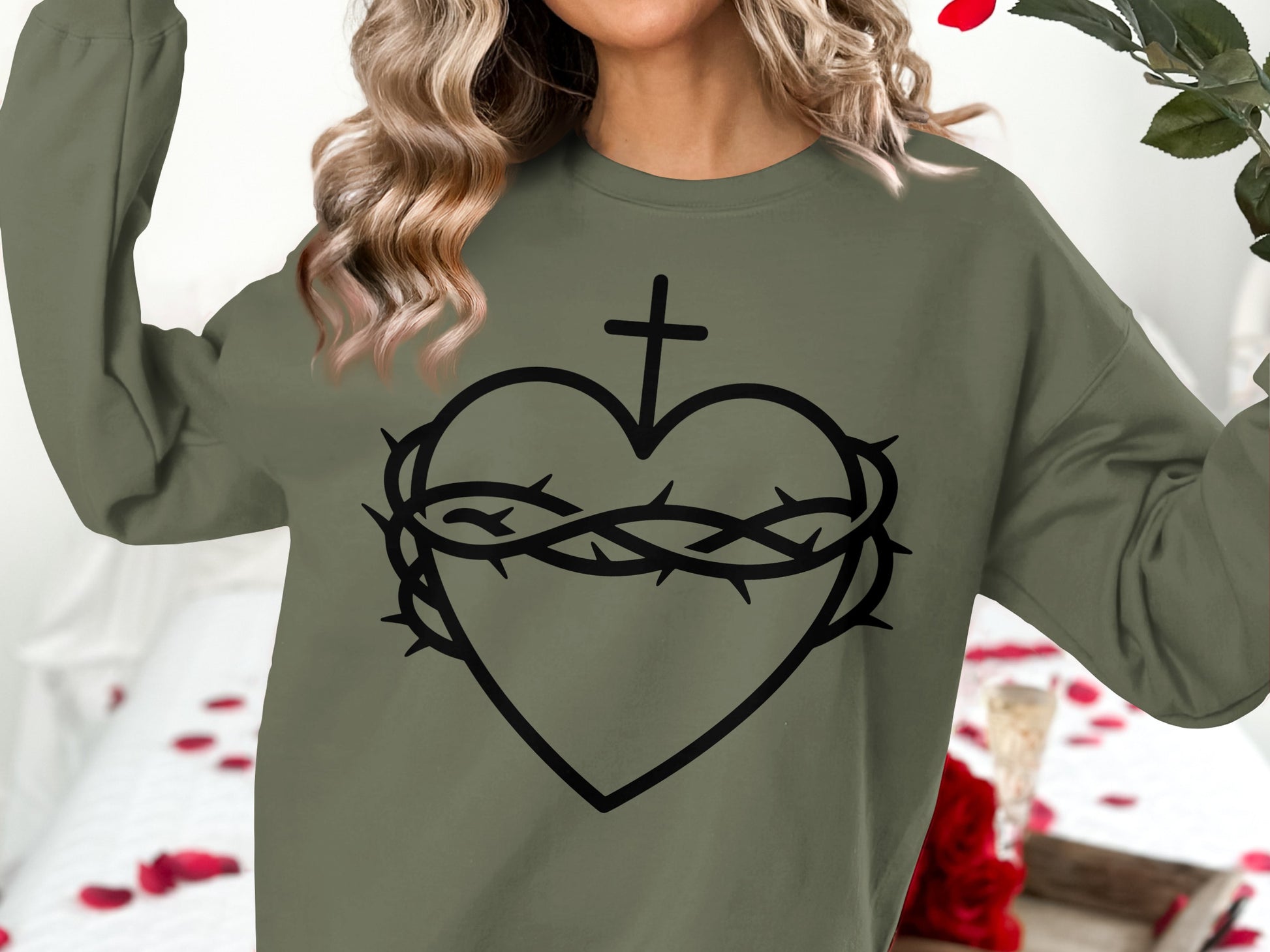 Olive green sweatshirt with a black outline of a heart, cross, and crown of thorns.