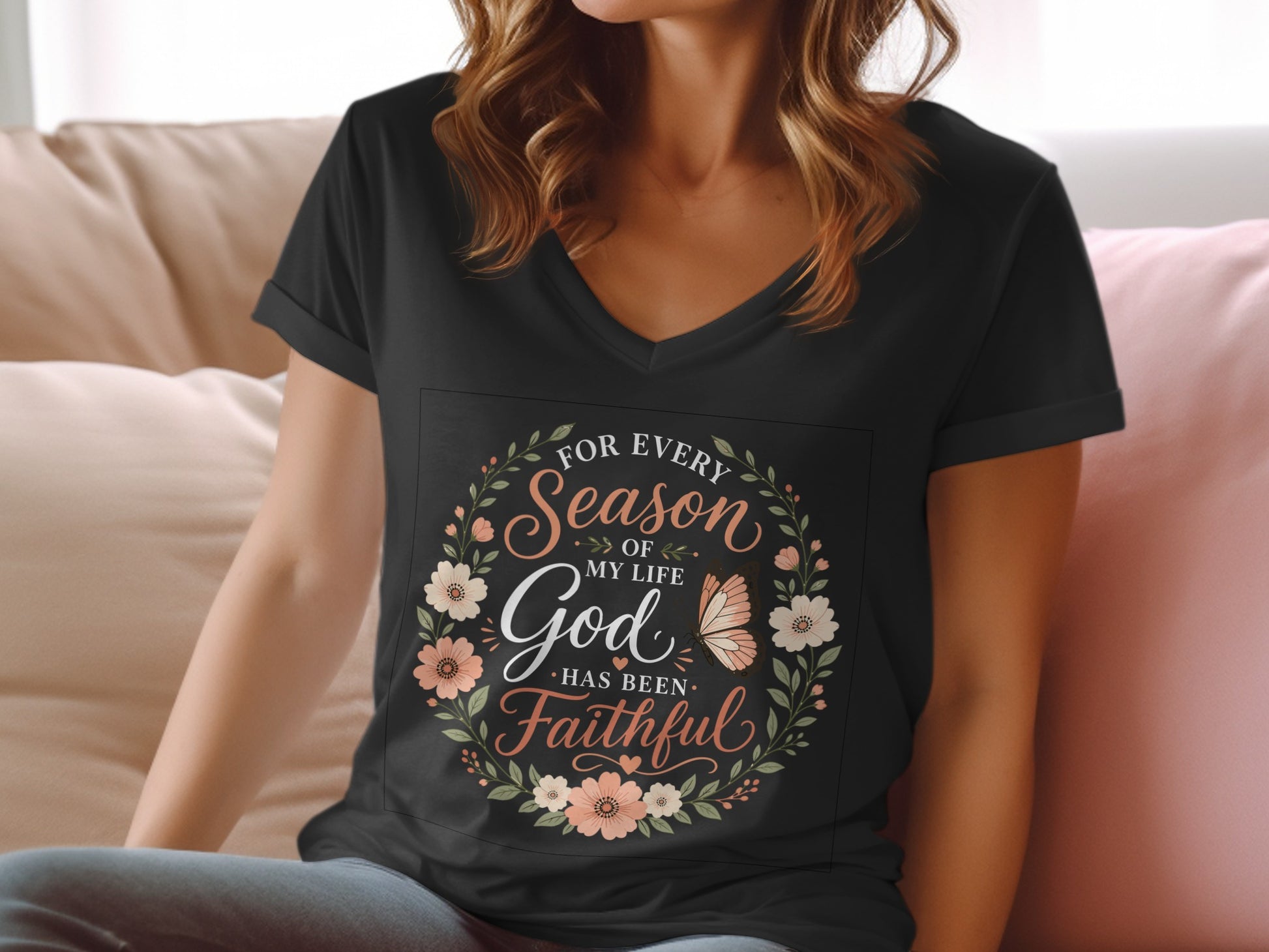 Black v-neck t-shirt with floral wreath and "God has been faithful" text.