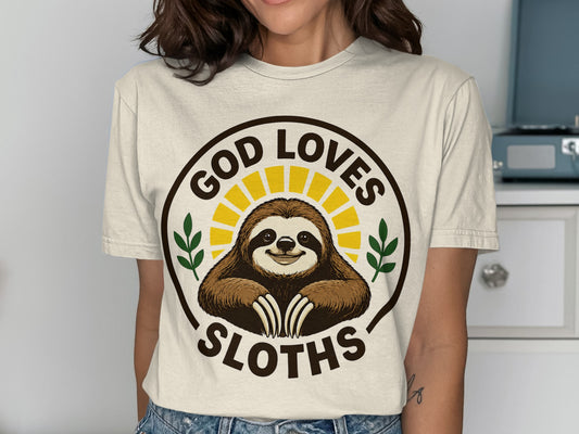 T-shirt with a smiling sloth in a sunburst circle, saying "God Loves Sloths".