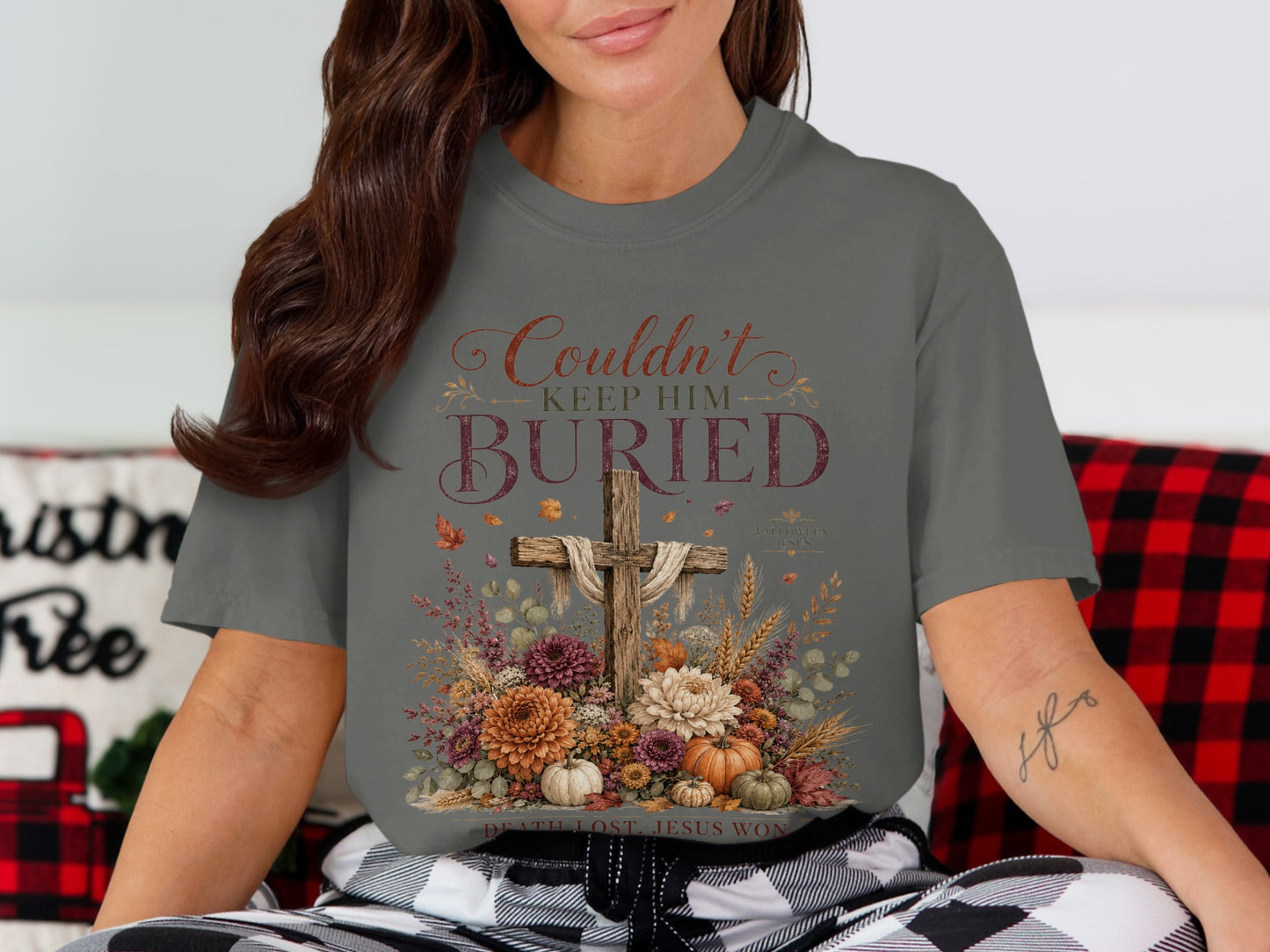 Gray t-shirt with a wooden cross, flowers, pumpkins, and text "Couldn't Keep Him Buried".