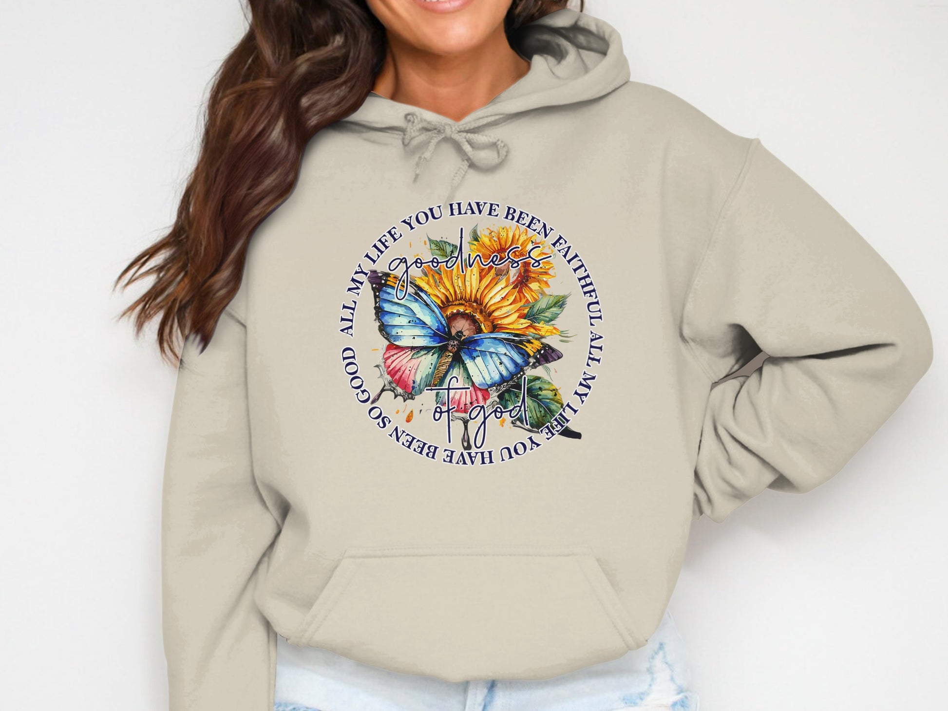 Beige hoodie with butterfly, sunflower, and text "ALL MY LIFE YOU HAVE BEEN FAITHFUL ALL MY LIFE YOU HAVE BEEN SO GOOD".