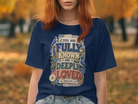 Navy t-shirt with "You are fully known and deeply loved" and bible verse.