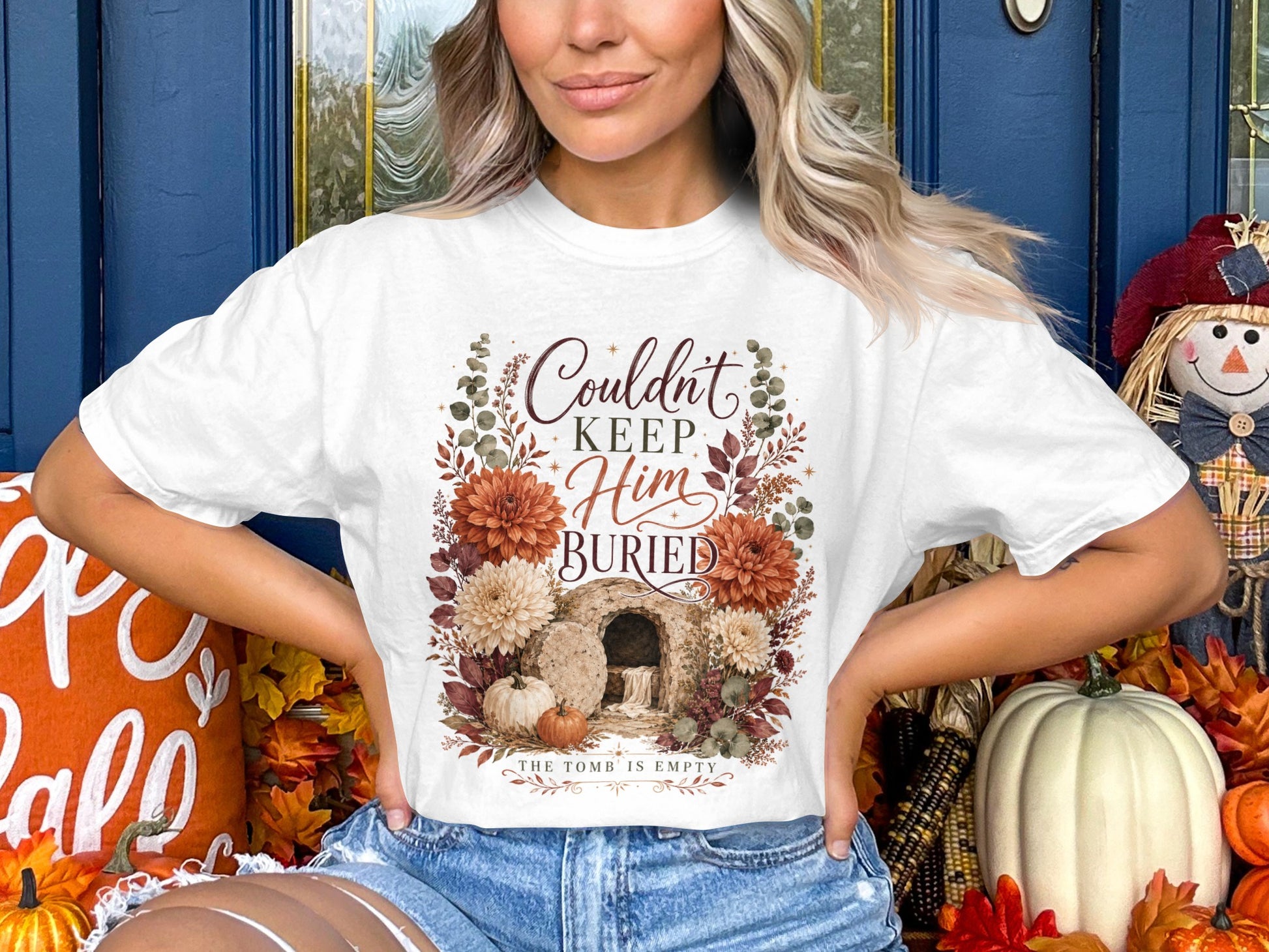 White t-shirt with "Couldn't Keep Him Buried" text and Easter tomb graphic.
