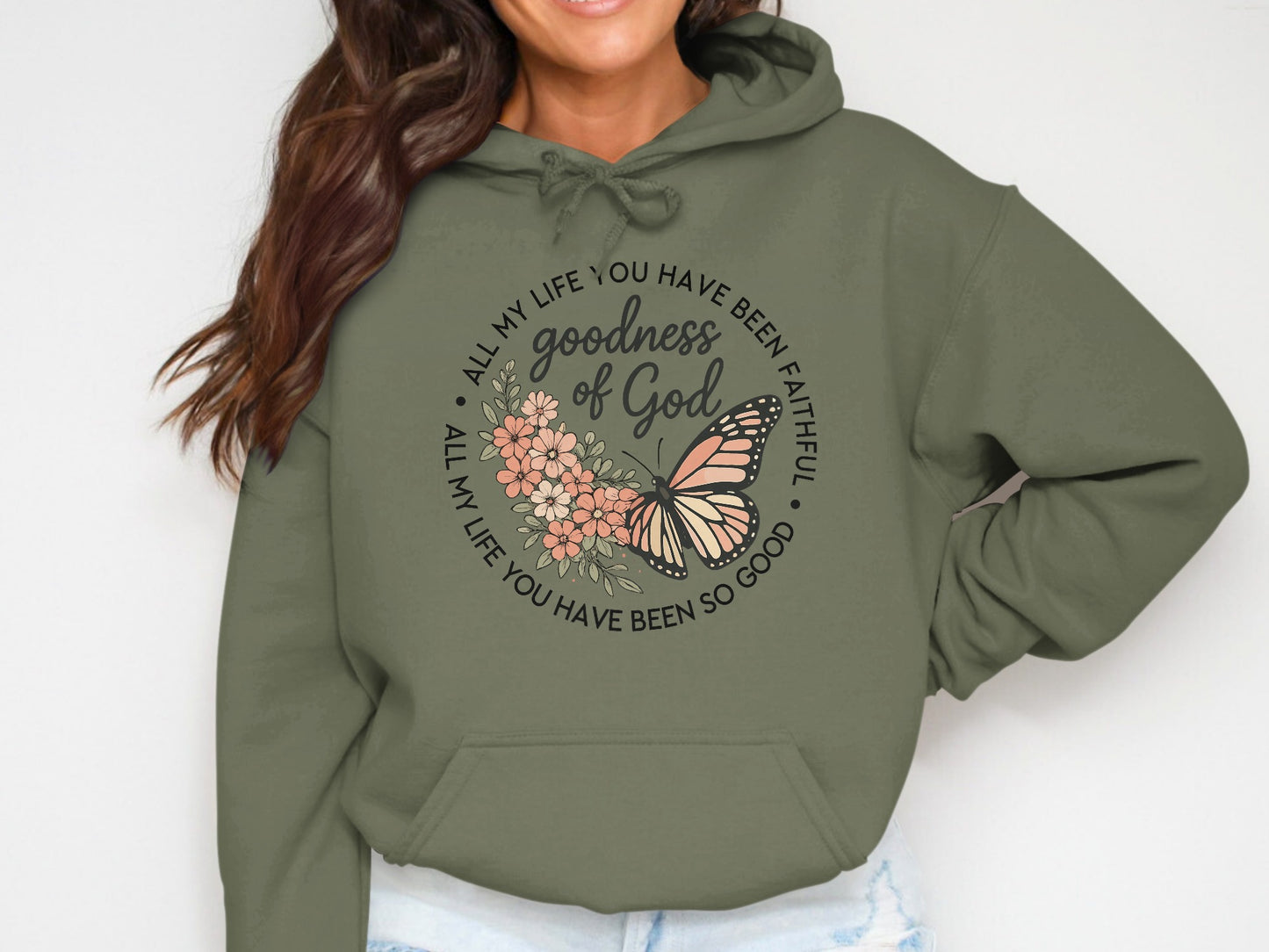 Olive green hoodie with floral and butterfly graphic; text says "All my life you have been faithful, goodness of God."