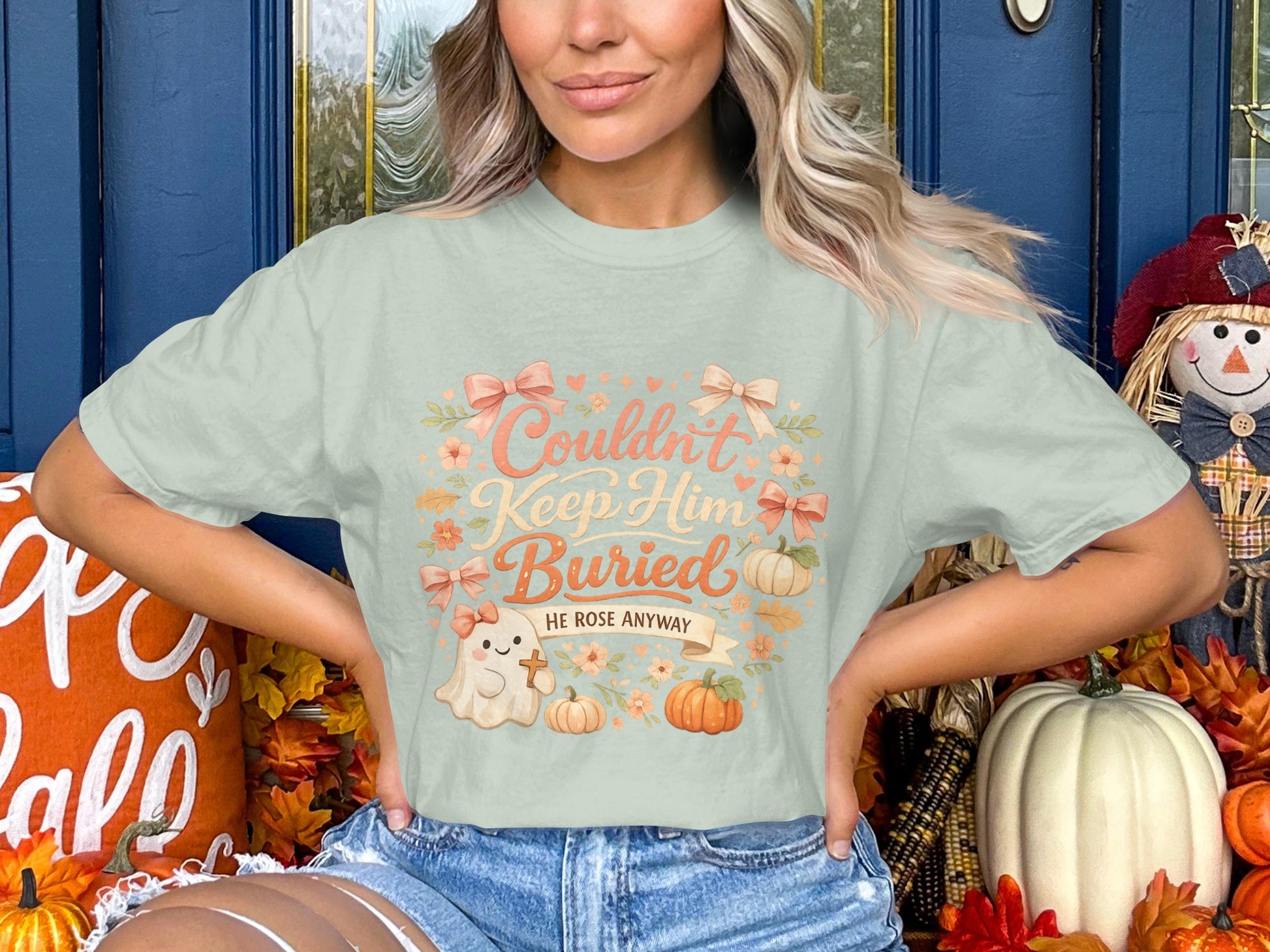 Light green t-shirt with "Couldn't Keep Him Buried HE ROSE ANYWAY" text and a ghost graphic.