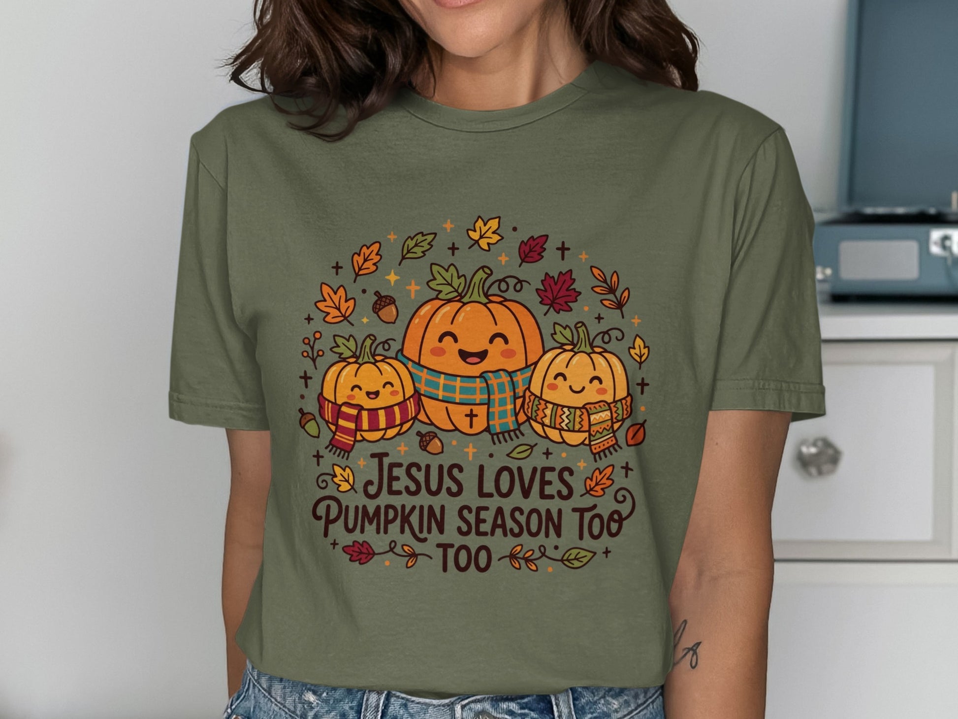 Three smiling pumpkins wearing scarves with "Jesus loves pumpkin season too" text.