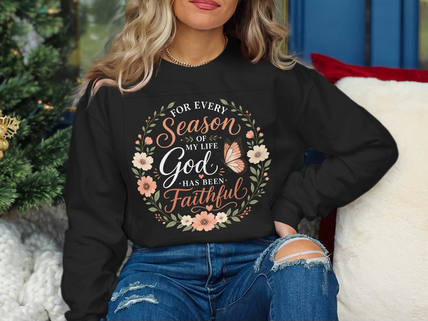 Black sweatshirt with floral wreath and "For every season of my life God has been faithful" text.