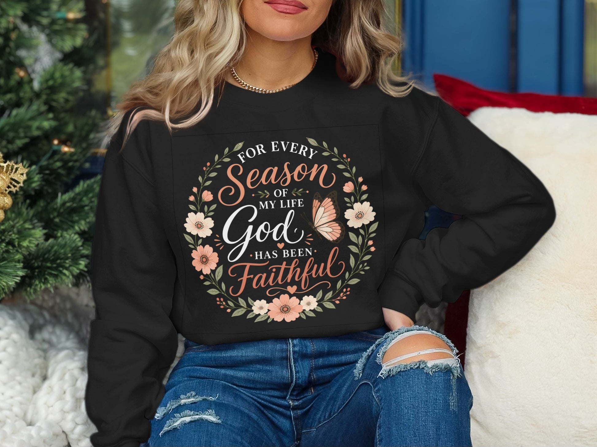 Black sweatshirt with floral wreath and "For every season of my life God has been faithful" text.