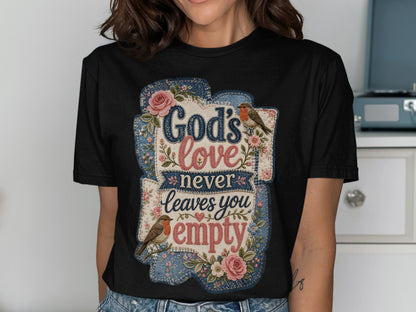 Black t-shirt with "God's love never leaves you empty" text and floral accents.