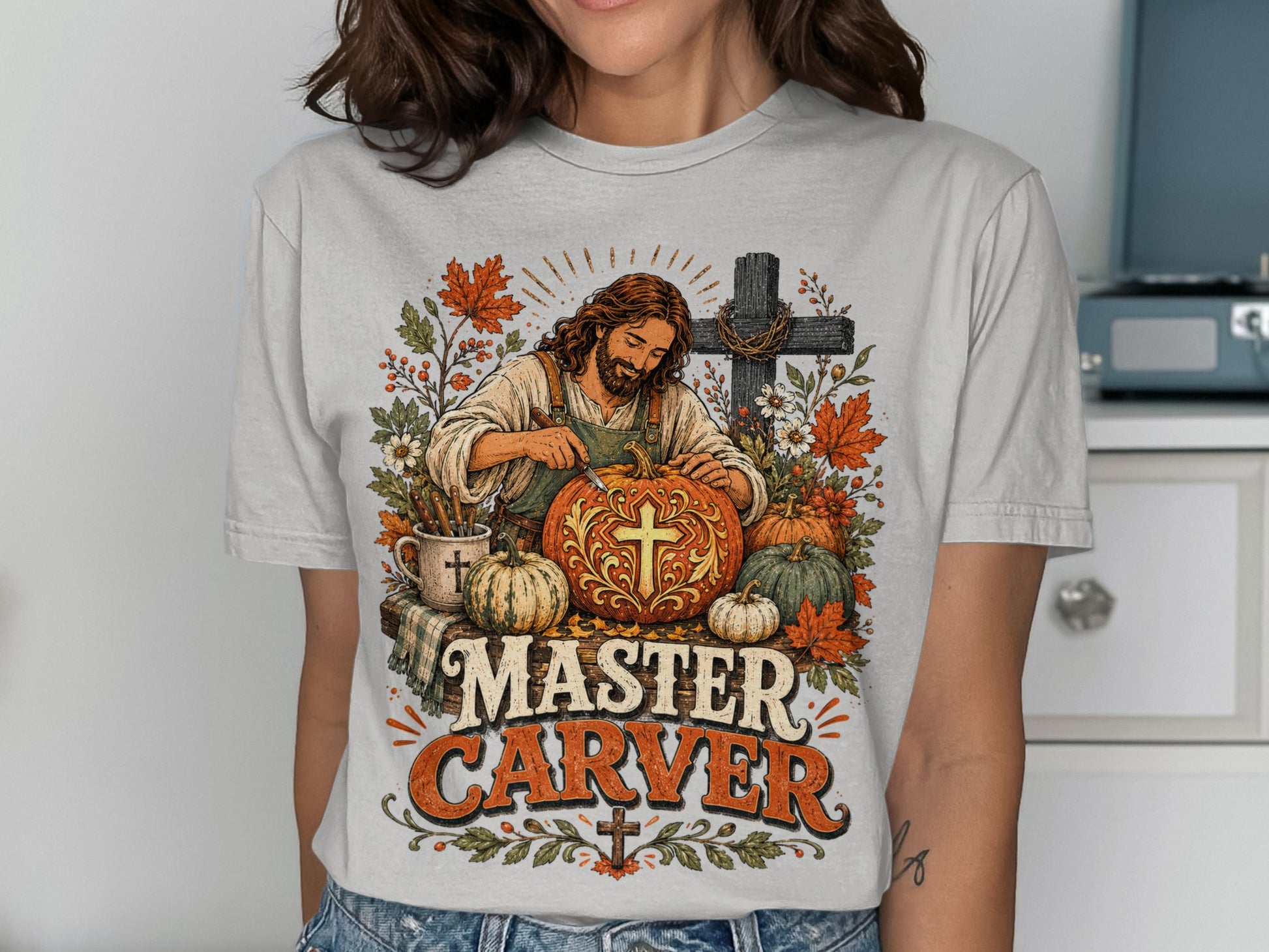 Jesus carving a pumpkin with "Master Carver" text and autumn leaves.