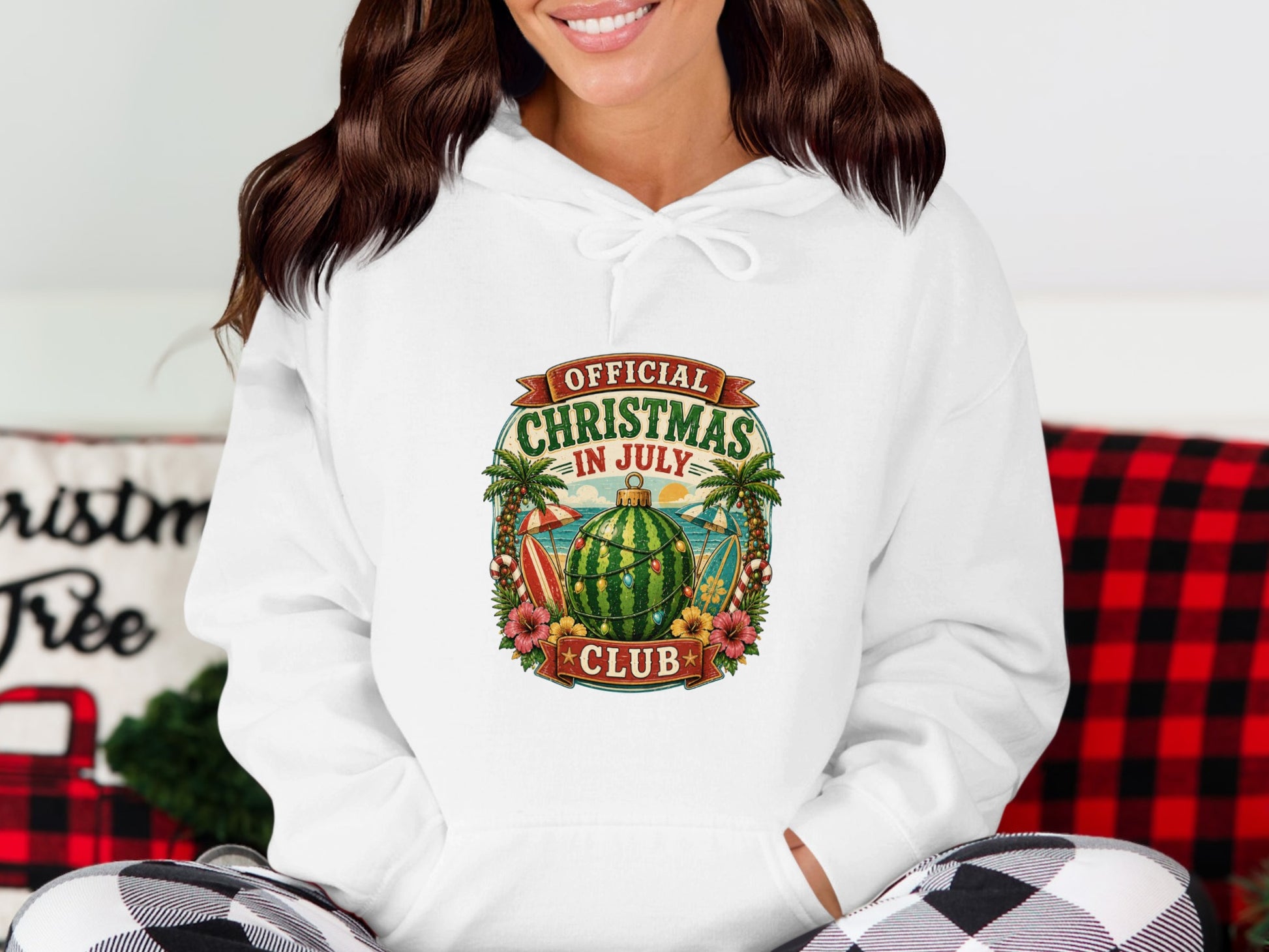 White hoodie with "Official Christmas in July Club" text and tropical holiday graphic.