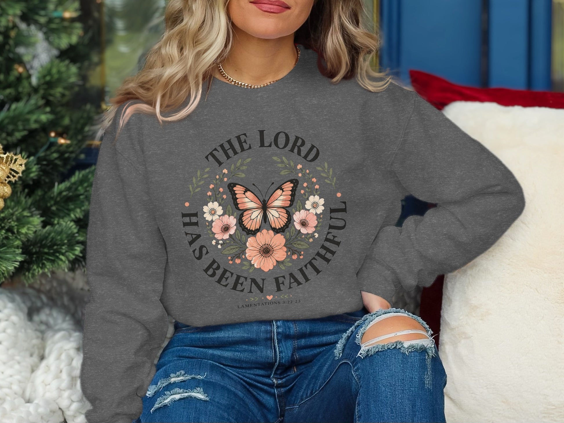 Gray sweatshirt with a butterfly and floral design, featuring "The Lord Has Been Faithful" text.