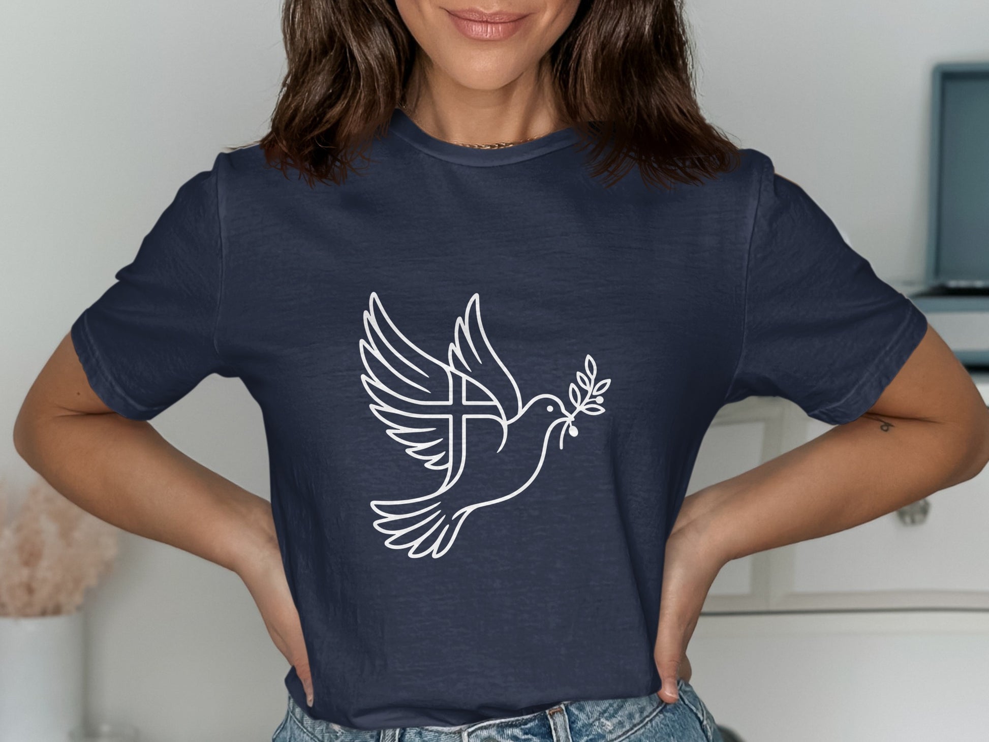 Navy t-shirt with white outline of a dove carrying an olive branch and a cross.