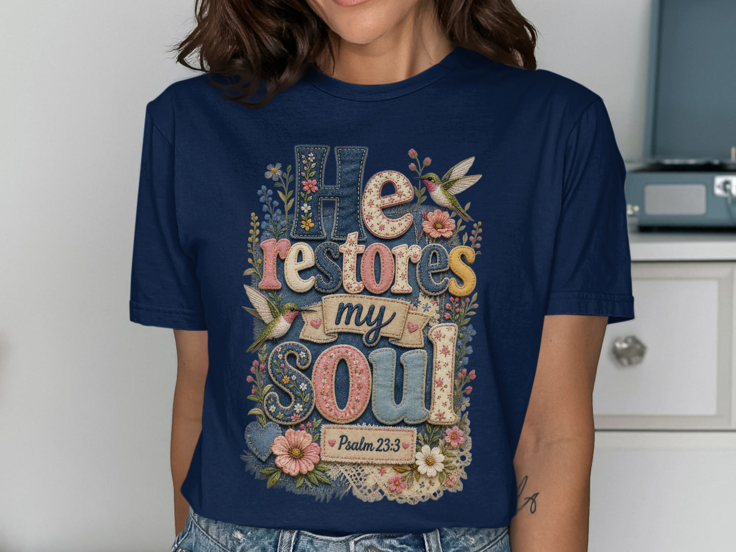 Navy t-shirt with "He restores my soul" and floral hummingbird design.