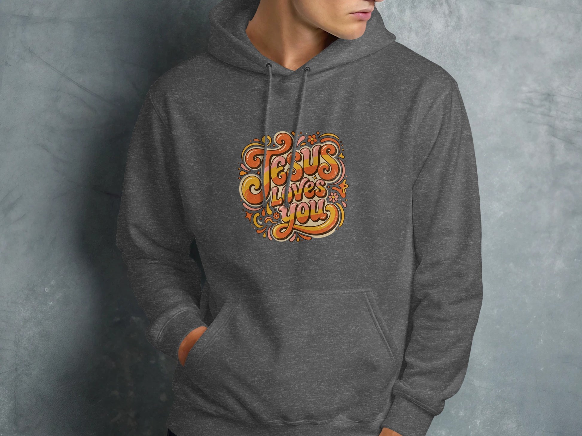 Dark grey hoodie with "Jesus loves you" in colorful retro script.