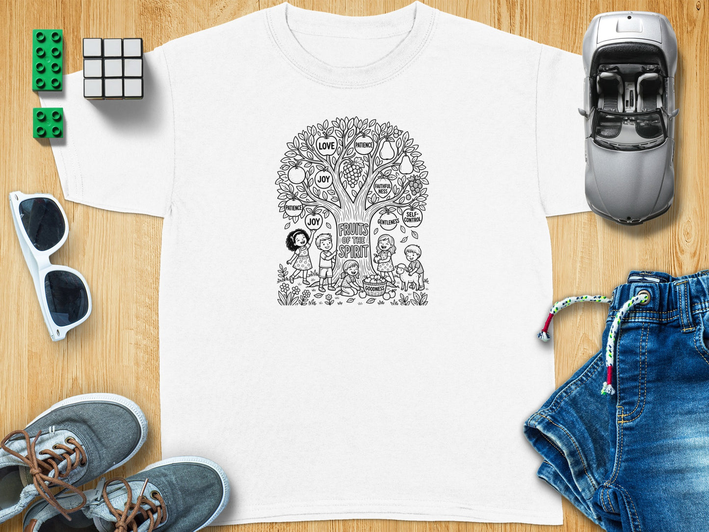 T-shirt design with "Fruits of the Spirit" theme and children around a tree.
