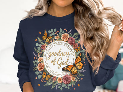 Navy sweatshirt with a floral wreath and butterflies featuring "goodness of God" text.
