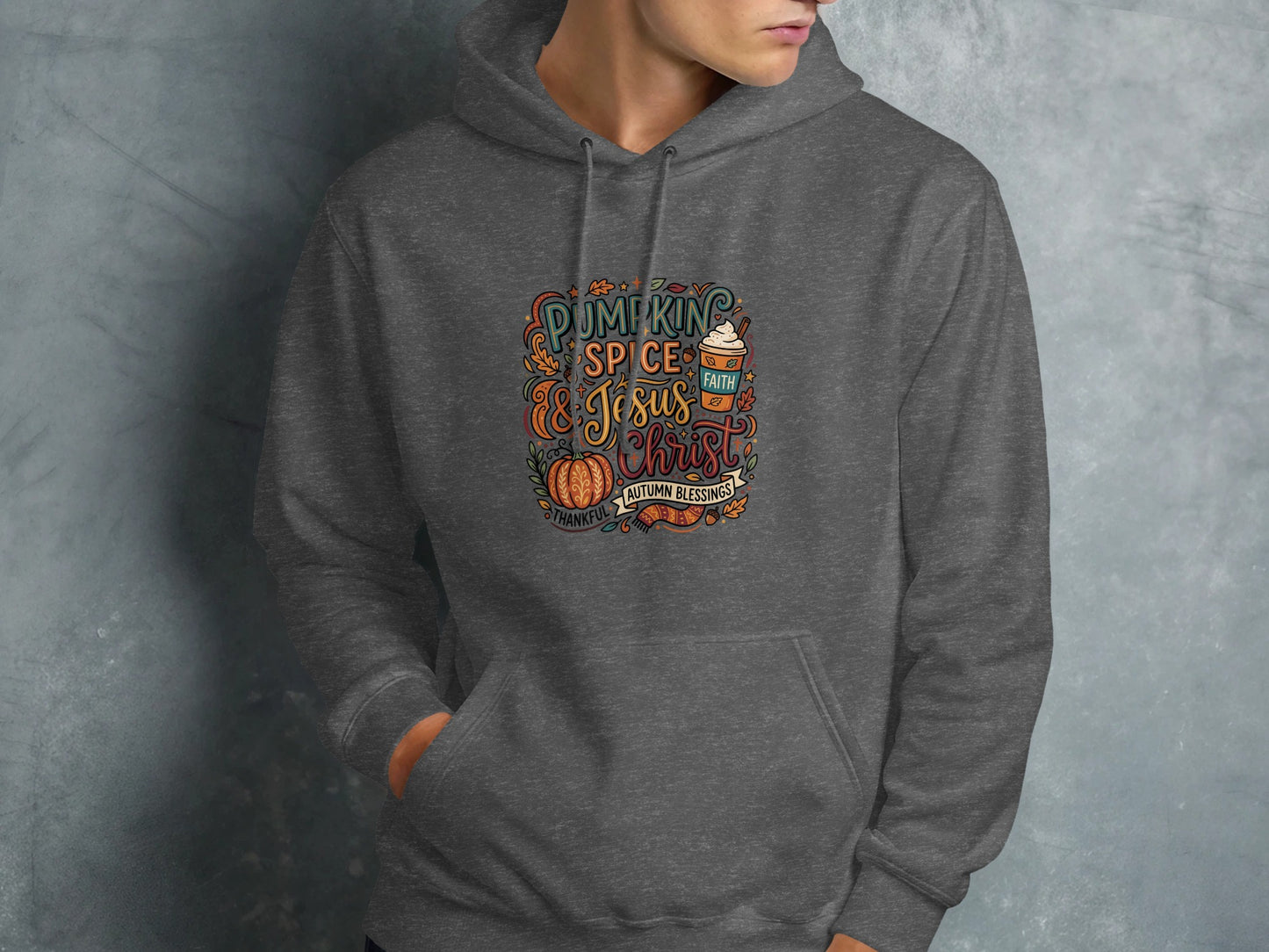 Dark grey hoodie with "Pumpkin Spice and Jesus Christ" autumn blessings graphic.
