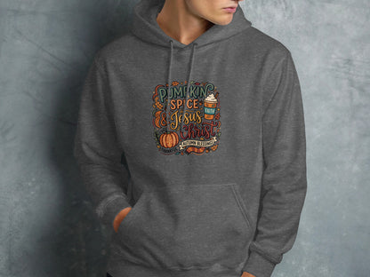 Dark grey hoodie with "Pumpkin Spice and Jesus Christ" autumn blessings graphic.