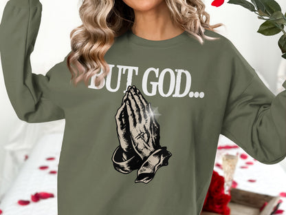 Olive green sweatshirt with praying hands and "BUT GOD..." text.