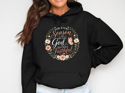Black hoodie with floral wreath and "God Has Been Faithful" text.