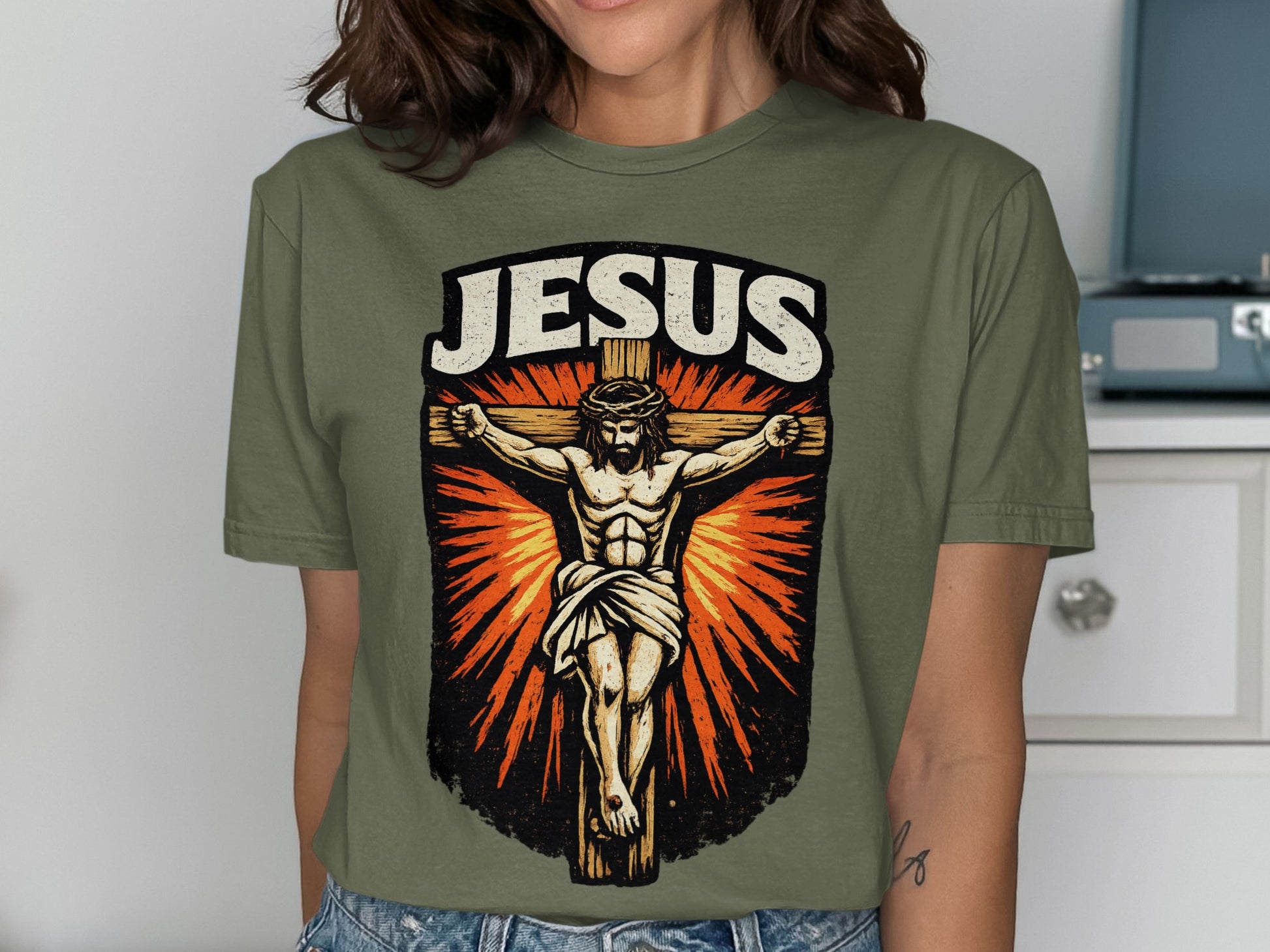 Olive green t-shirt with Jesus Christ crucifixion graphic and "JESUS" text.