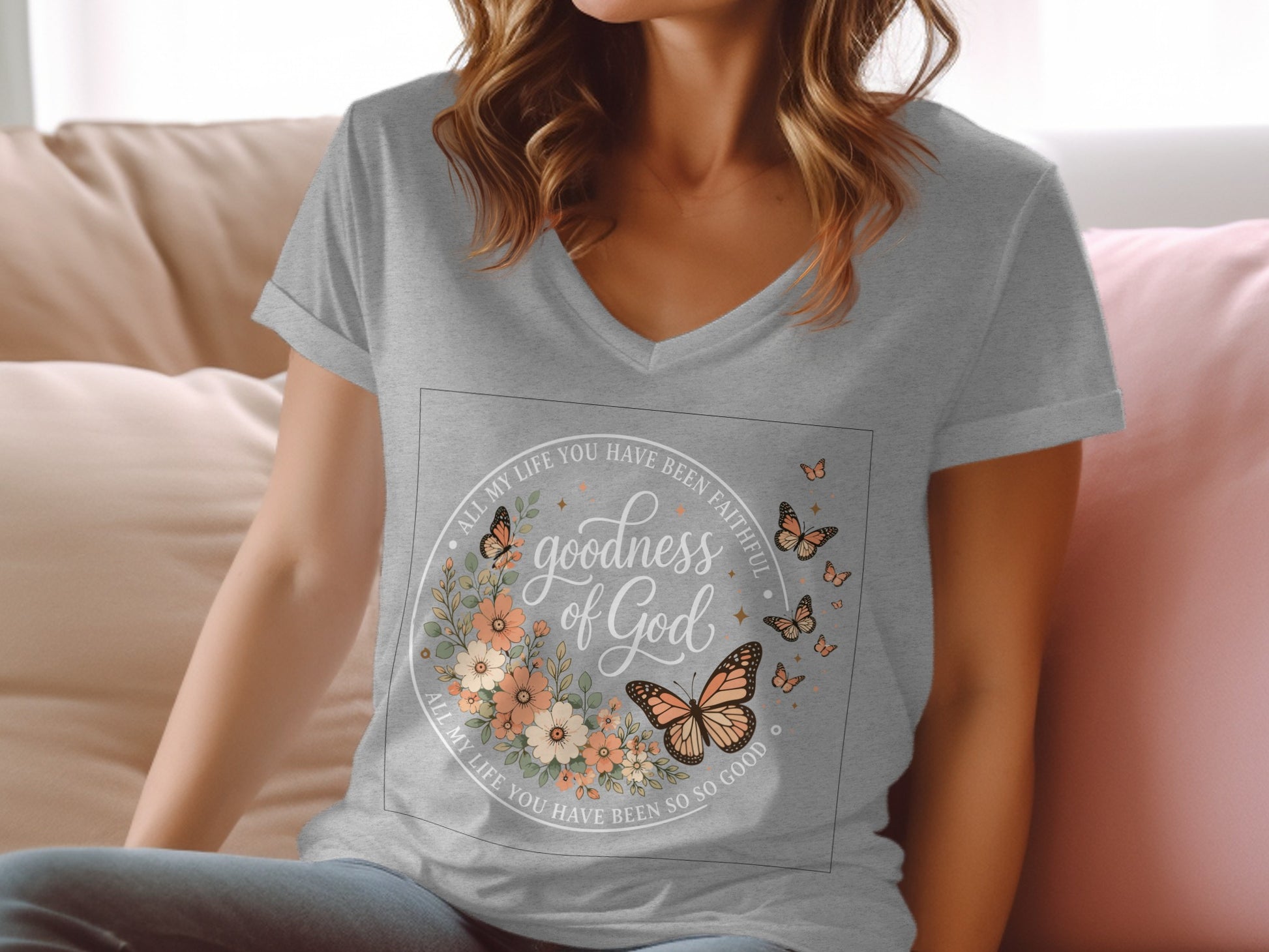 Grey v-neck t-shirt with "goodness of God" and butterfly floral design.