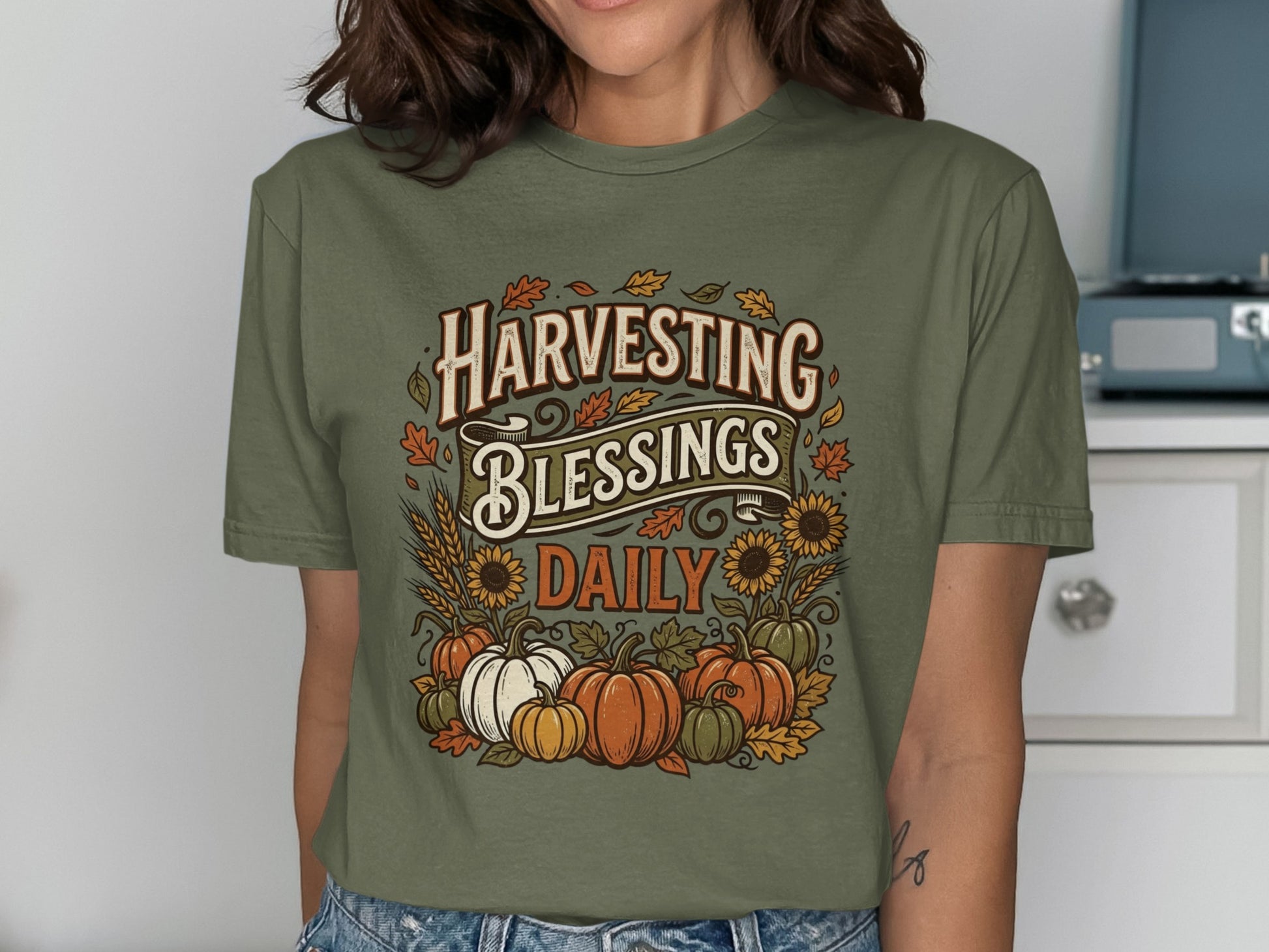 Olive green t-shirt with "Harvesting Blessings Daily" and autumn produce graphic.
