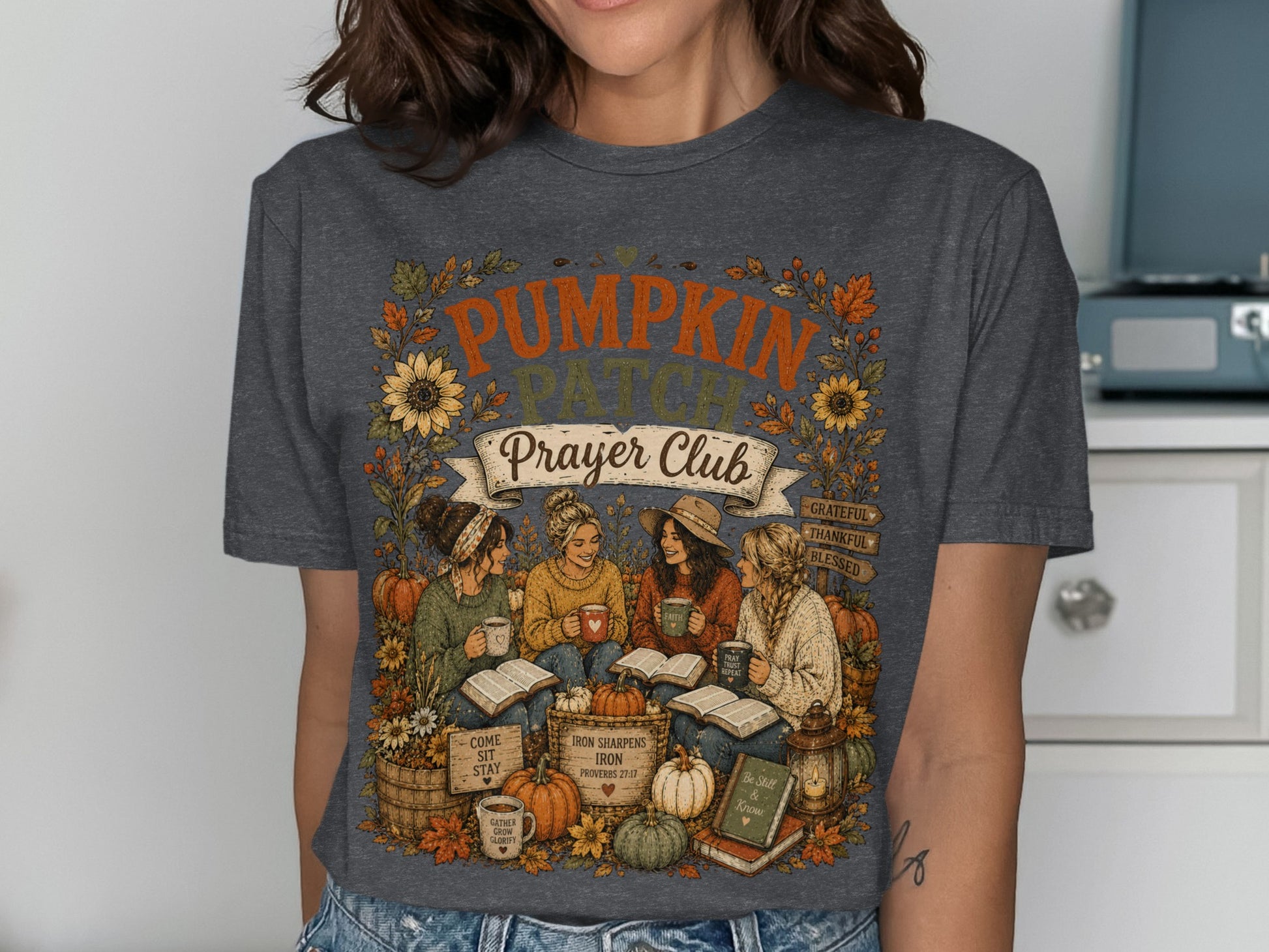 Dark t-shirt with "Pumpkin Prayer Club" and autumn illustrations.