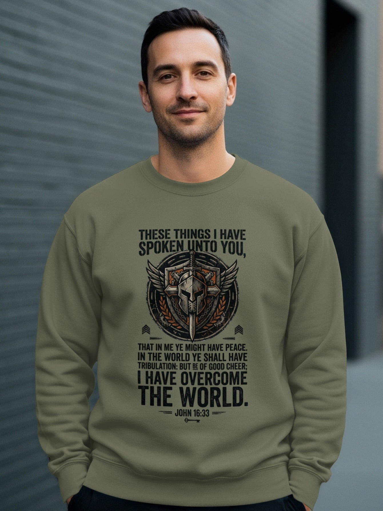 Olive sweatshirt with helmet, wings, and John 16:33 Bible verse.