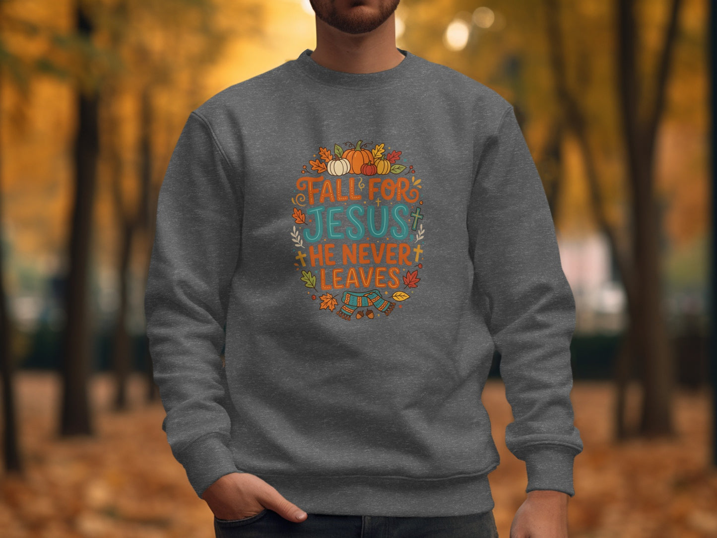 Dark gray crewneck sweatshirt with "Fall for Jesus He Never Leaves" text and fall graphics.