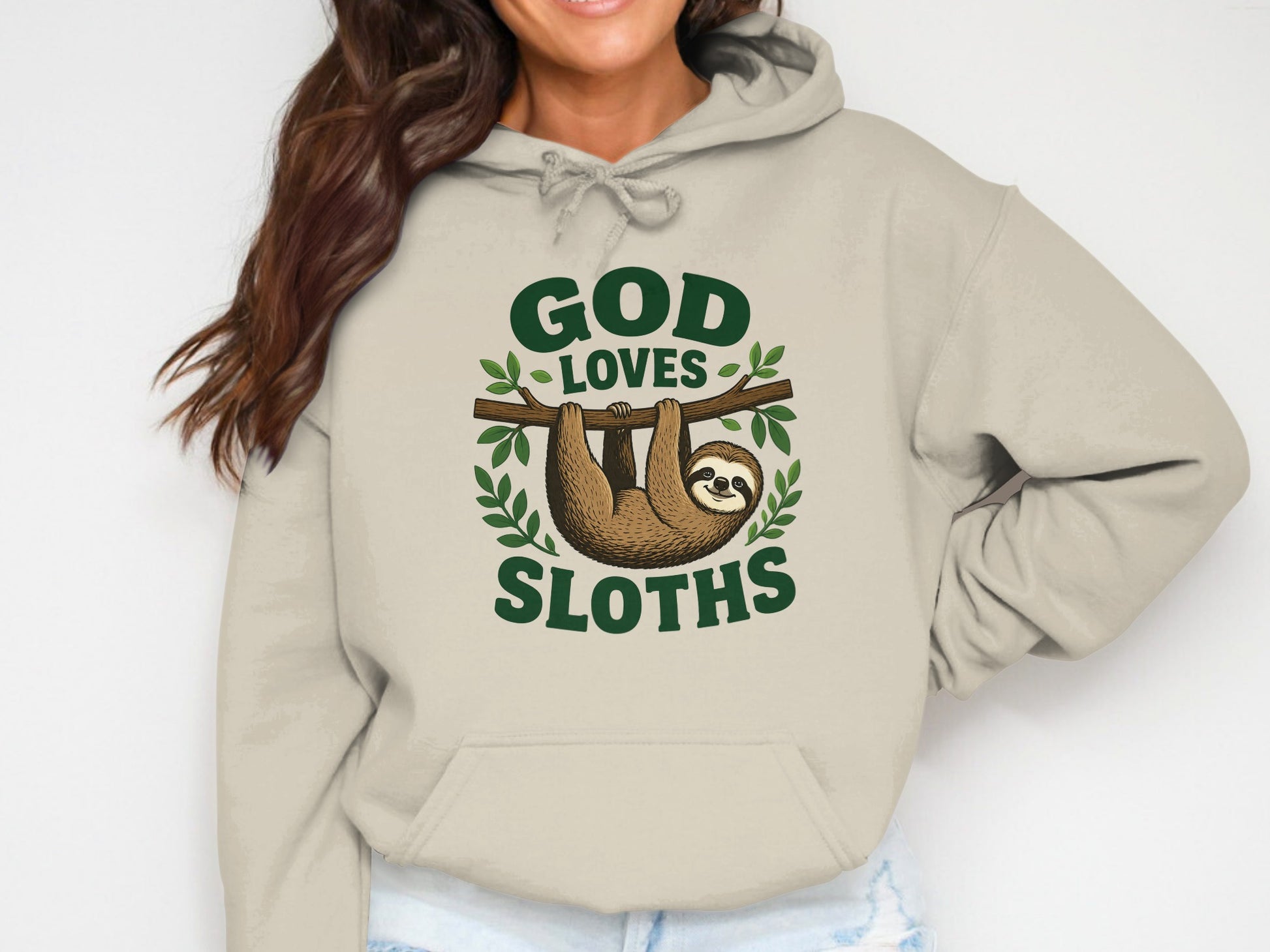 Beige hoodie with "God Loves Sloths" text and a sloth hanging on a branch.