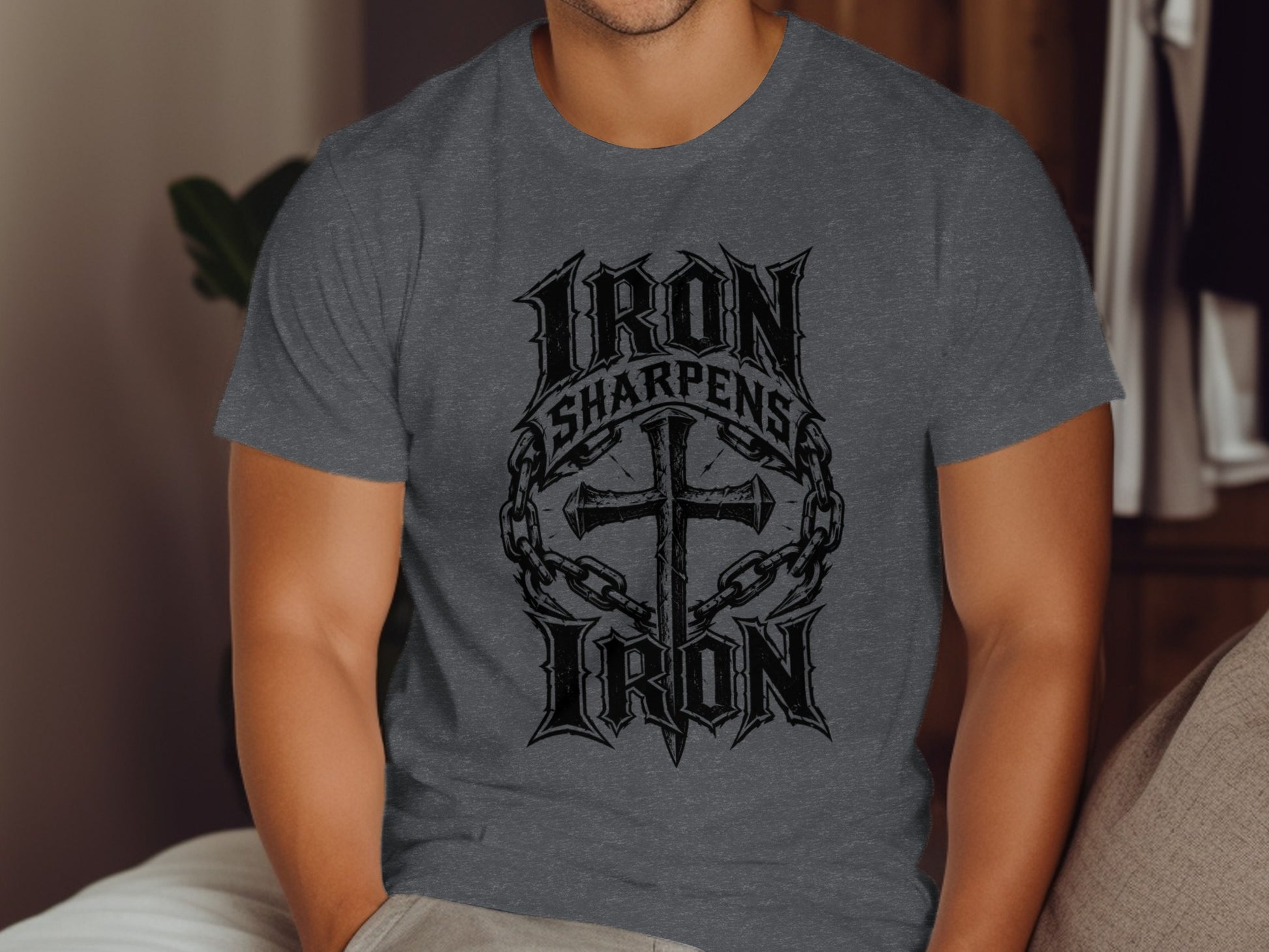 Dark gray t-shirt with "Iron Sharpens Iron" text and a cross emblem.